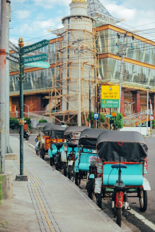 Rickshaws Parked Next to a Shopping Mall