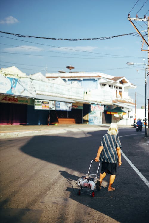 A Woman Walking with a Trolley