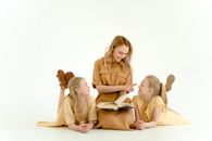Woman in Brown Long Sleeve Shirt Sitting Beside Boy in Brown Long Sleeve Shirt