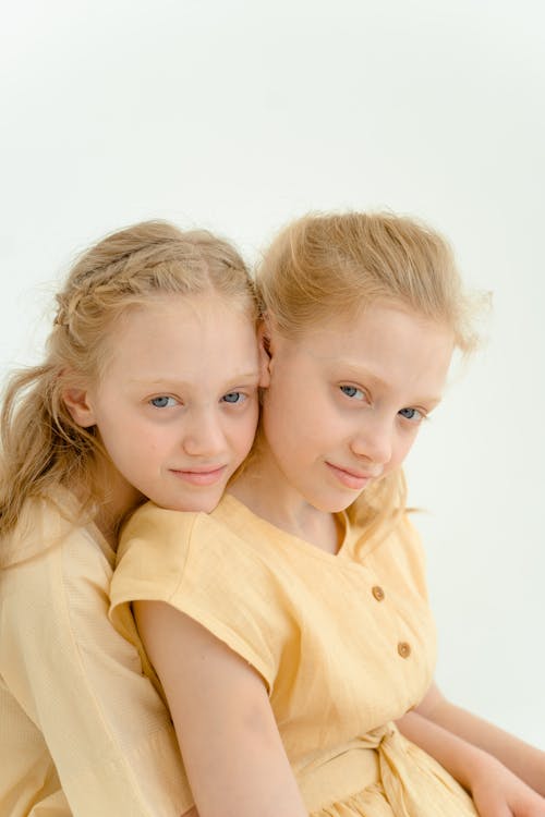 Girl in Yellow Button Up Shirt Beside Girl in Yellow Shirt