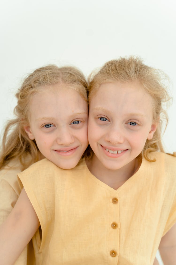 Portrait Of Twins Smiling Together