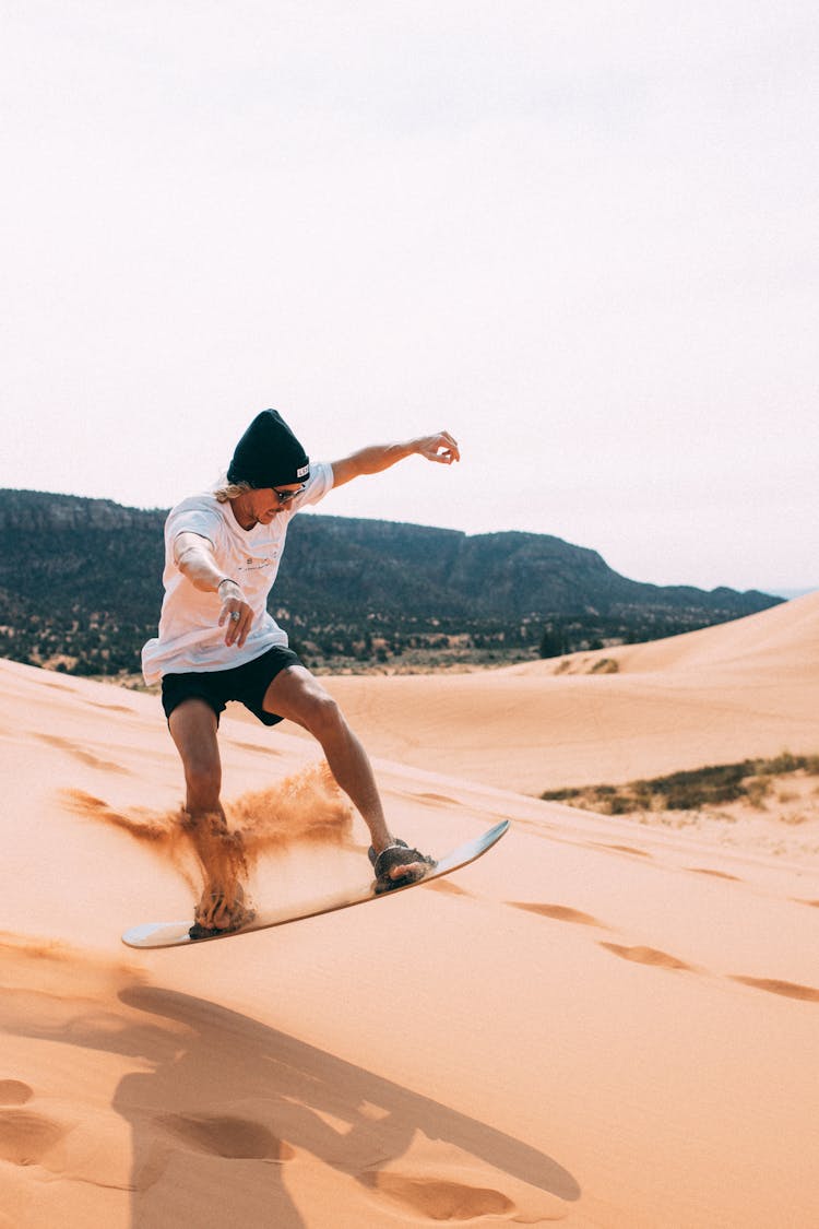 Woman In White Shirt And Brown Shorts Riding On Brown And Black Skateboard