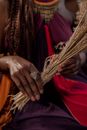 A Person Holding a Bundled Dried Leaves Tied with a Rope