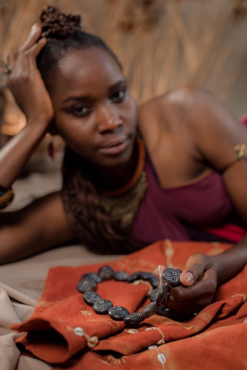 Model wearing a handmade necklace, photographed by cottonbro studio on Pexels