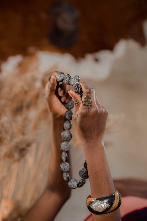 Person Holding a Bead Necklace