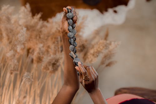 Person Holding Beaded Necklace