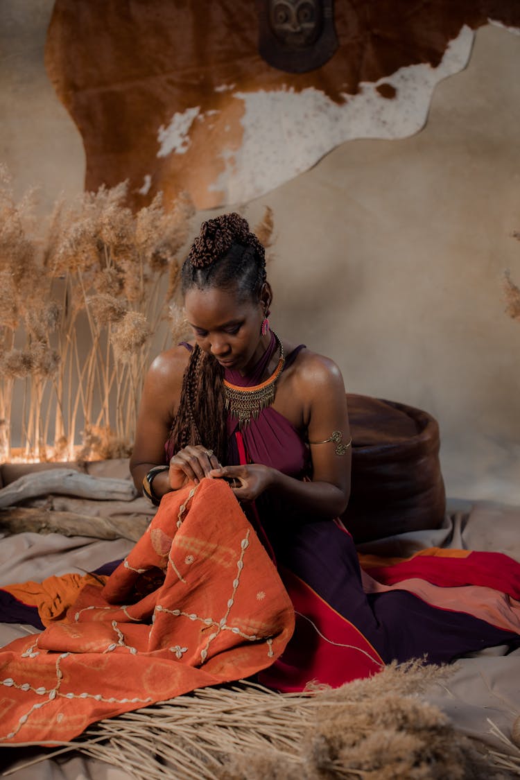 A Woman Holding A Orange Fabric