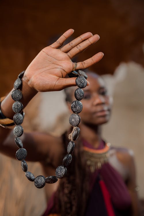 A Woman Holding a Bead Necklace