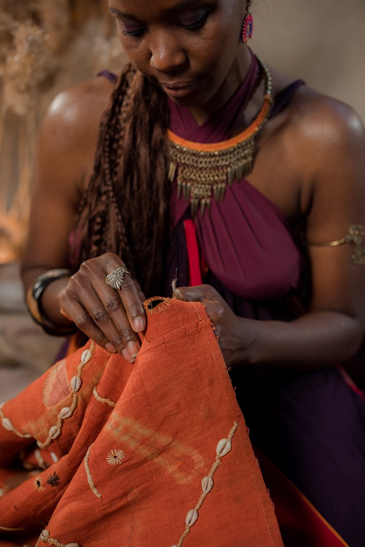 A Woman Sewing A Fabric