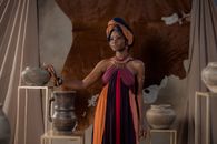 Woman in Blue and Red Sleeveless Dress Holding Gray Steel Pot