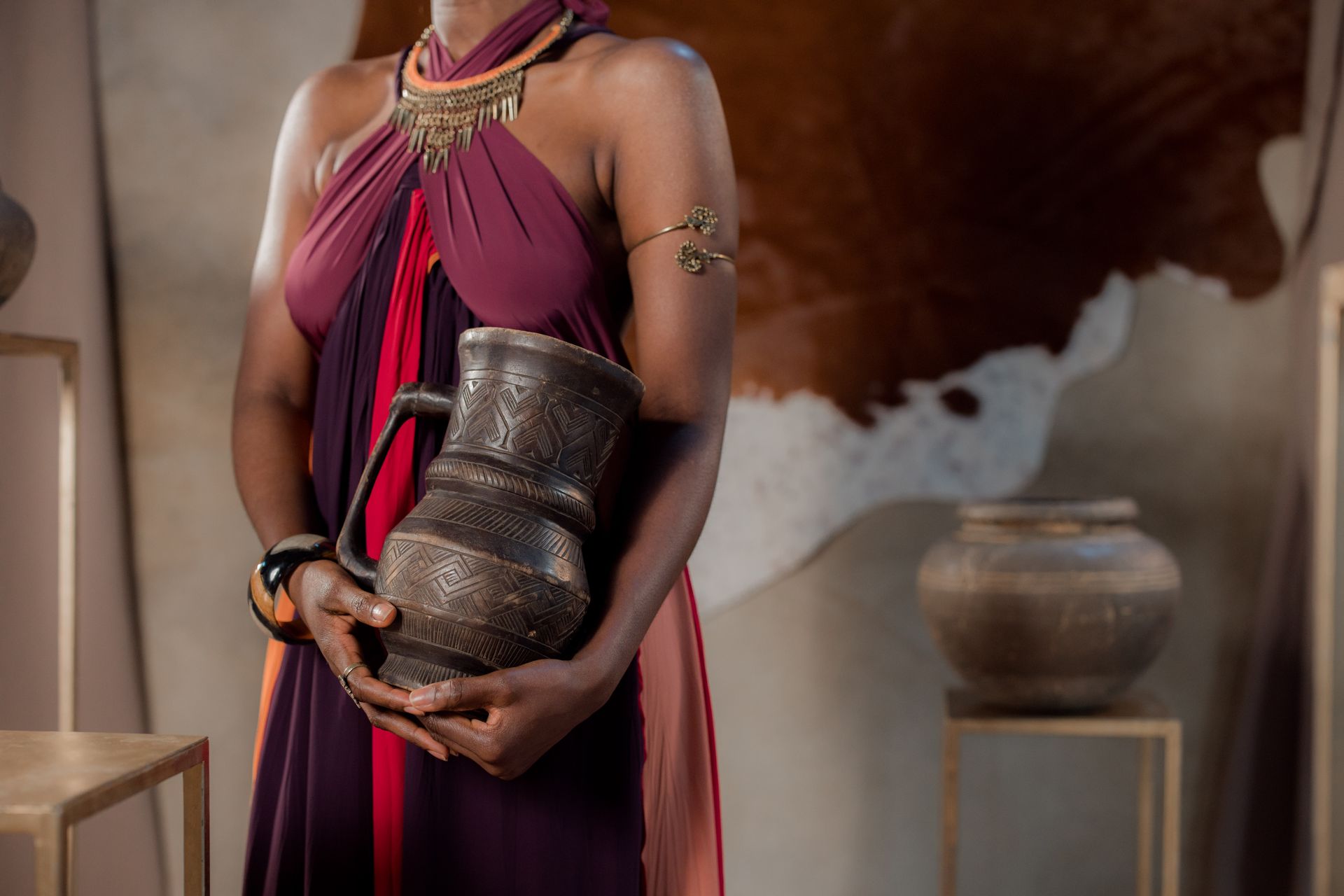 Woman in a Dress Holding an Ancient Vase