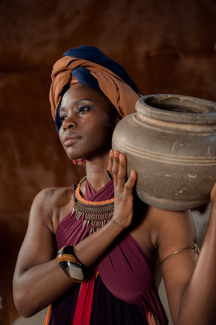 Woman Carrying A Jar