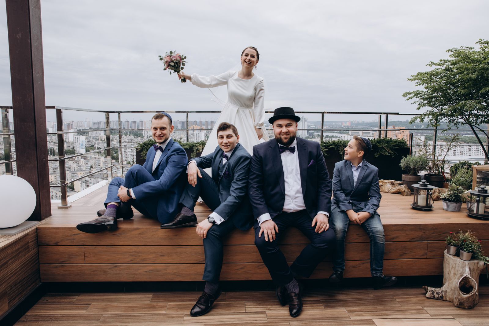 Wedding couple and guests posing together outdoors