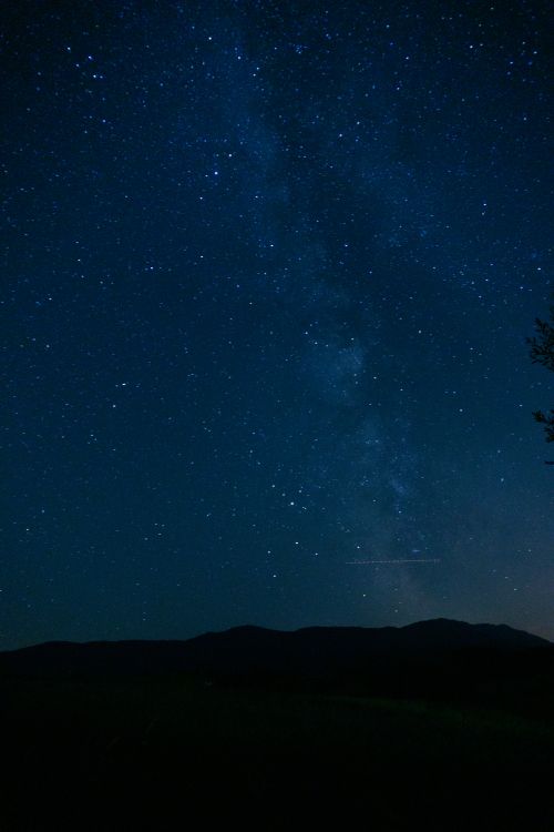 Free A breathtaking view of the starry night sky over the Bavarian mountains in Oberammergau, Germany. Stock Photo