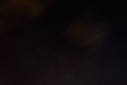 Free A serene night sky dotted with stars, featuring a hint of cloud coverage, perfect for tranquil themes. Stock Photo