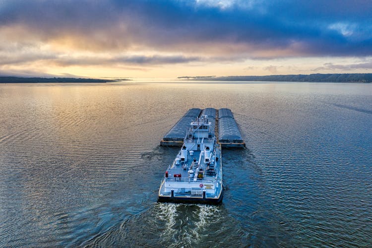 A Barge With Shipments Cruising Across The Ocean