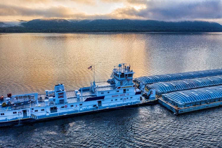 A Ship Pulling Barges Of Cargo