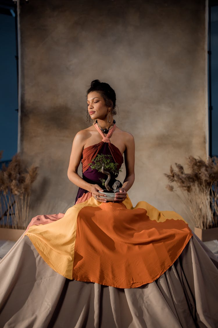 Woman Holding Bonsai Tree