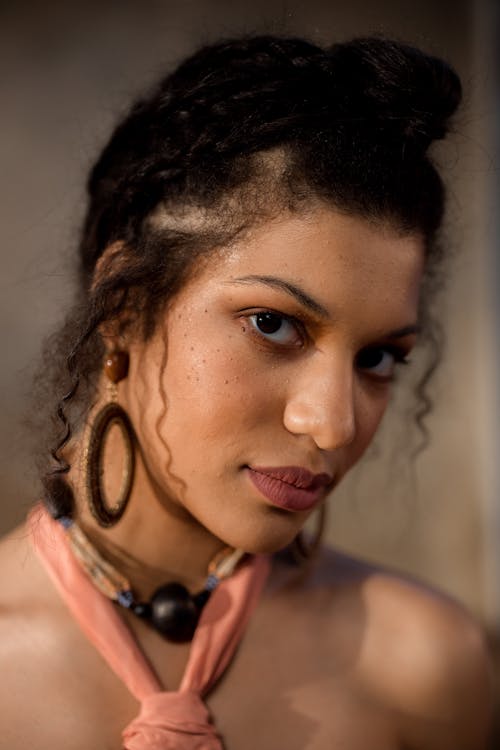 Woman in Pink Top Wearing Hoop Earrings