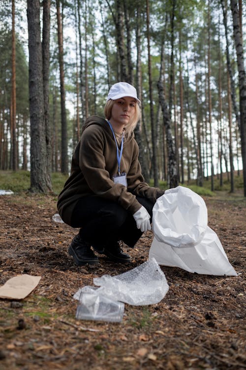 A Cleanup Volunteer Picking Up Recyclables from the Ground