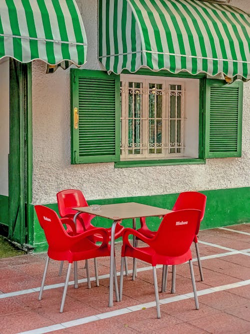 Free Table and Red Chairs Outside the Restaurant Stock Photo