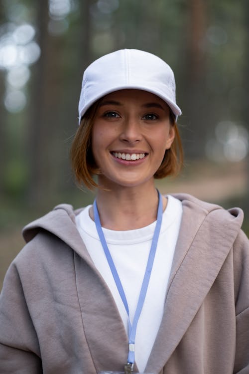 Smiling Woman in White Cap and Gray Coat