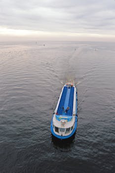 Aerial view of a blue cargo boat navigating calm waters in Saint Petersburg.