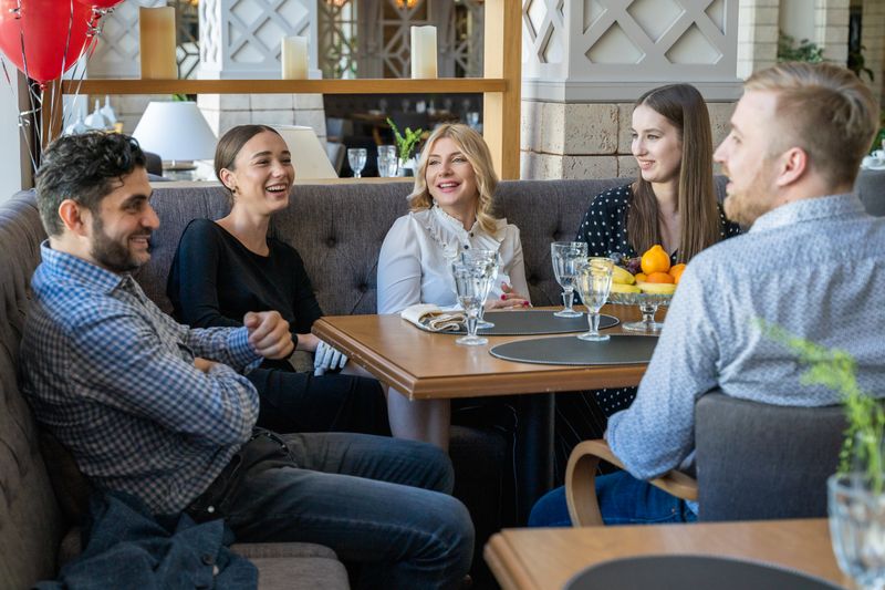 Colleagues in conversation over dinner at a restaurant, Mikhail Nilov on Pexels