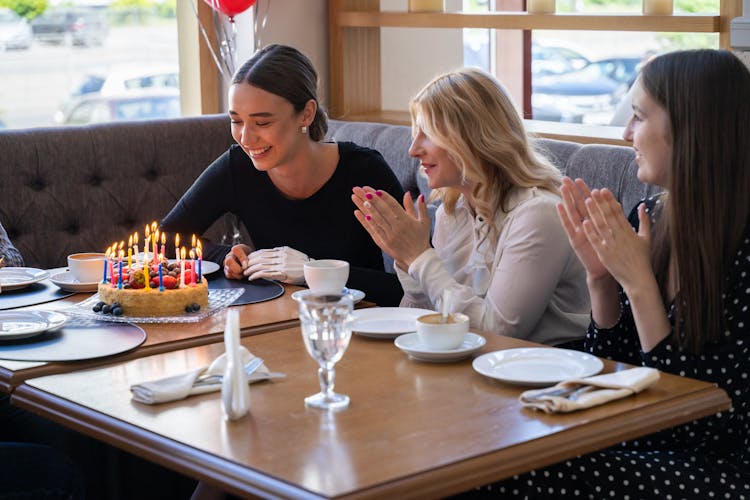 Happy Woman Looking At Her Birthday Cake