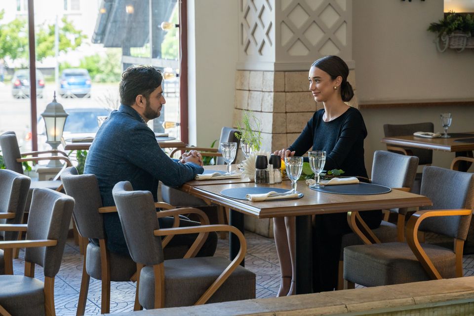A man and woman sharing a meal in a cozy café