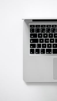 Simple composition of a laptop keyboard on white, ideal for tech themes.