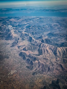 Stunning aerial photo showcasing a vast and rugged mountain landscape with visible terrain details.