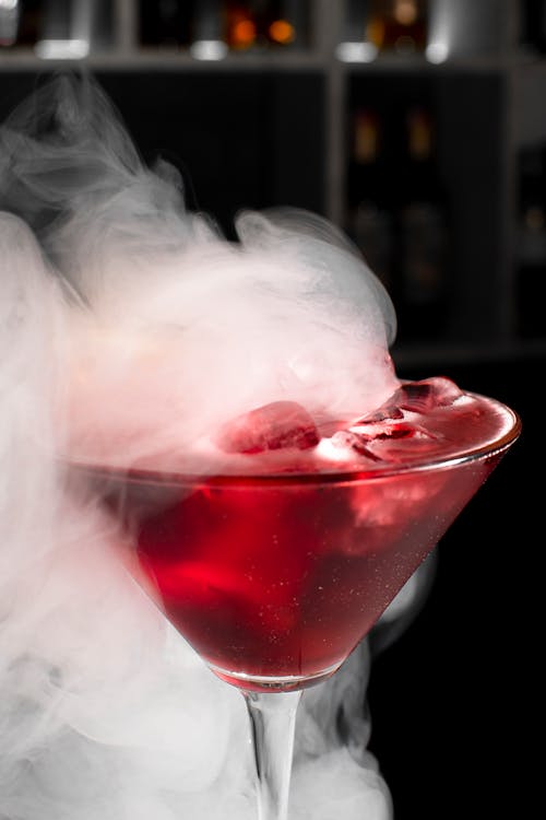 Red Liquid Nitrogen Cocktail Drink in Clear Glass