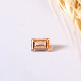 Amber-toned emerald-cut gemstone, photo by The Glorious Studio on Pexels