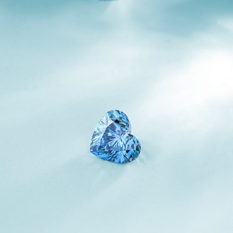 Aquamarine Heart Shape Gemstone On Light Blue Background