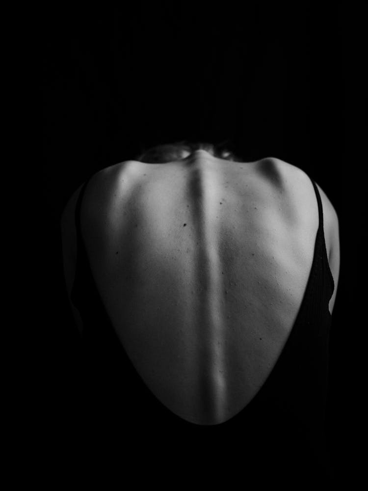 Grayscale Photo Of A Person's Backbone