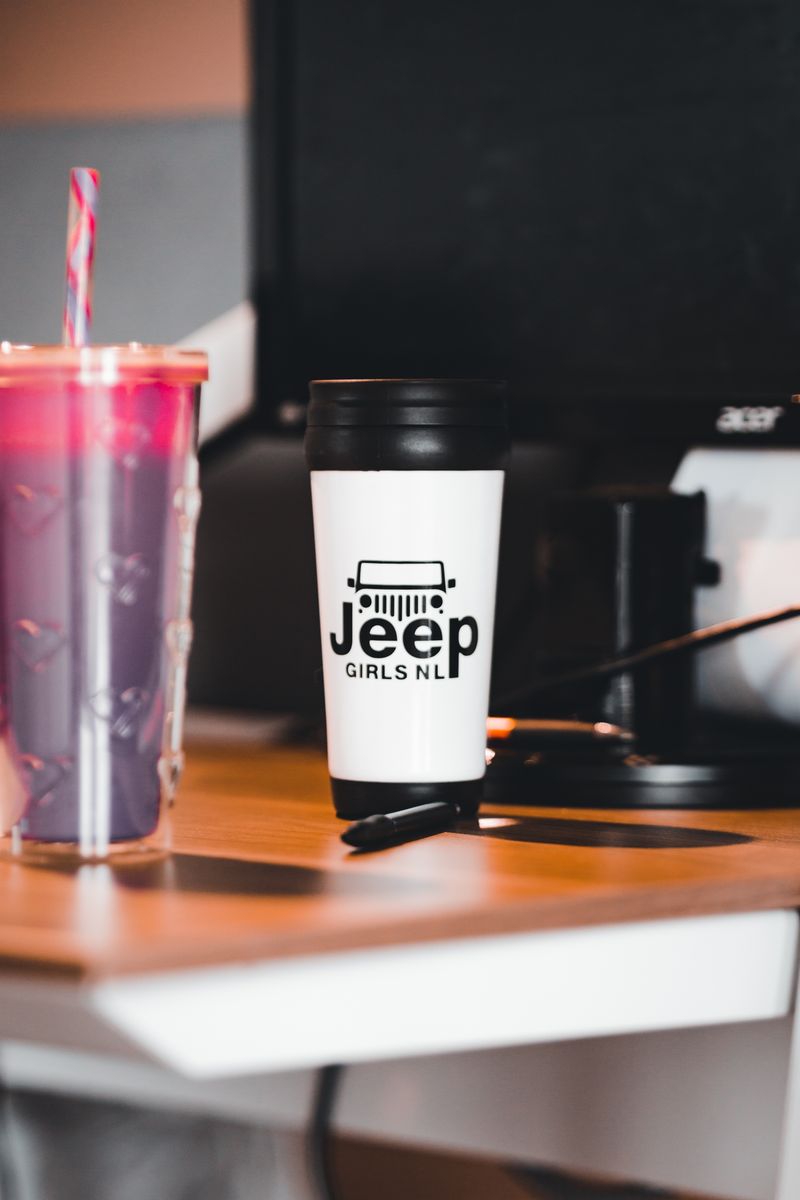 Insulated tumblers on a desk, ready for laser engraving with your logo