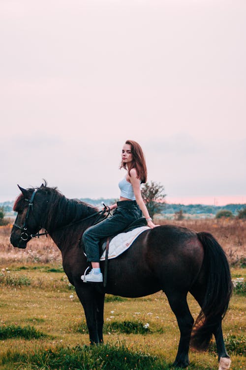 Woman Riding A Black Horse