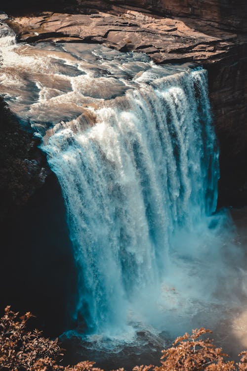 Waterfalls Cascading From Rocky Mountain