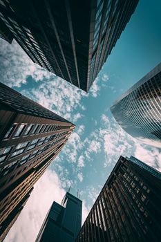 Low angle view of Chicago skyscrapers with Willis Tower against a blue sky.