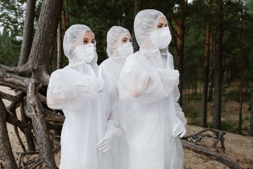 Free Three People Wearing White Hazmat Suits Stock Photo