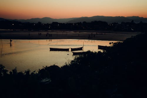 Silhouettes of Boats During Sunset