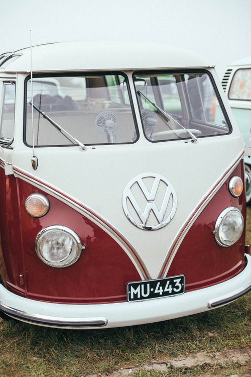 Free Close-up of a classic vintage Volkswagen van in red and white parked outdoors. Stock Photo