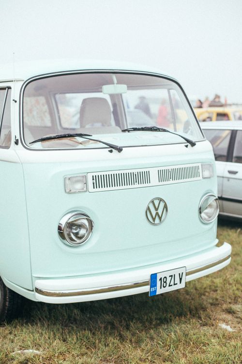 Free Retro light blue Volkswagen van parked on green grass, showcasing classic style. Stock Photo