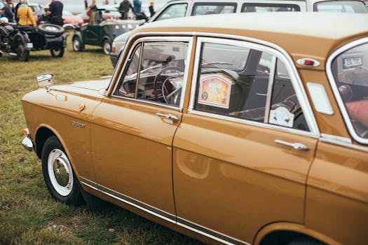 Close-up of a vintage classic car on display at an outdoor auto show.
