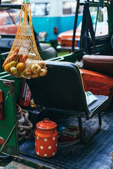 Retro pickup truck with fresh produce in mesh bag and nostalgic items inside.