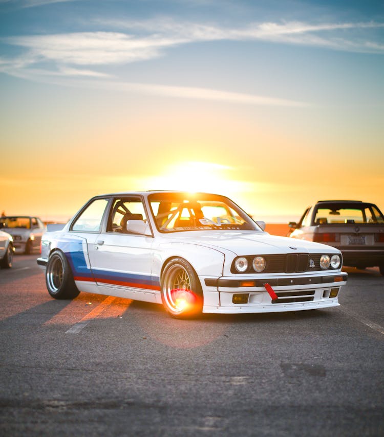 White BMW Sports Car On A Parking Lot During Sunset