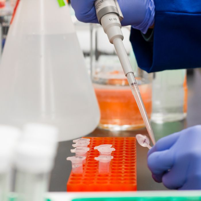 A drop being added to a test tube with a pipette