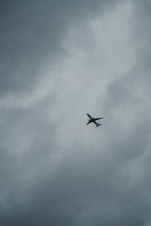 Airplane Flying in the Cloudy Sky