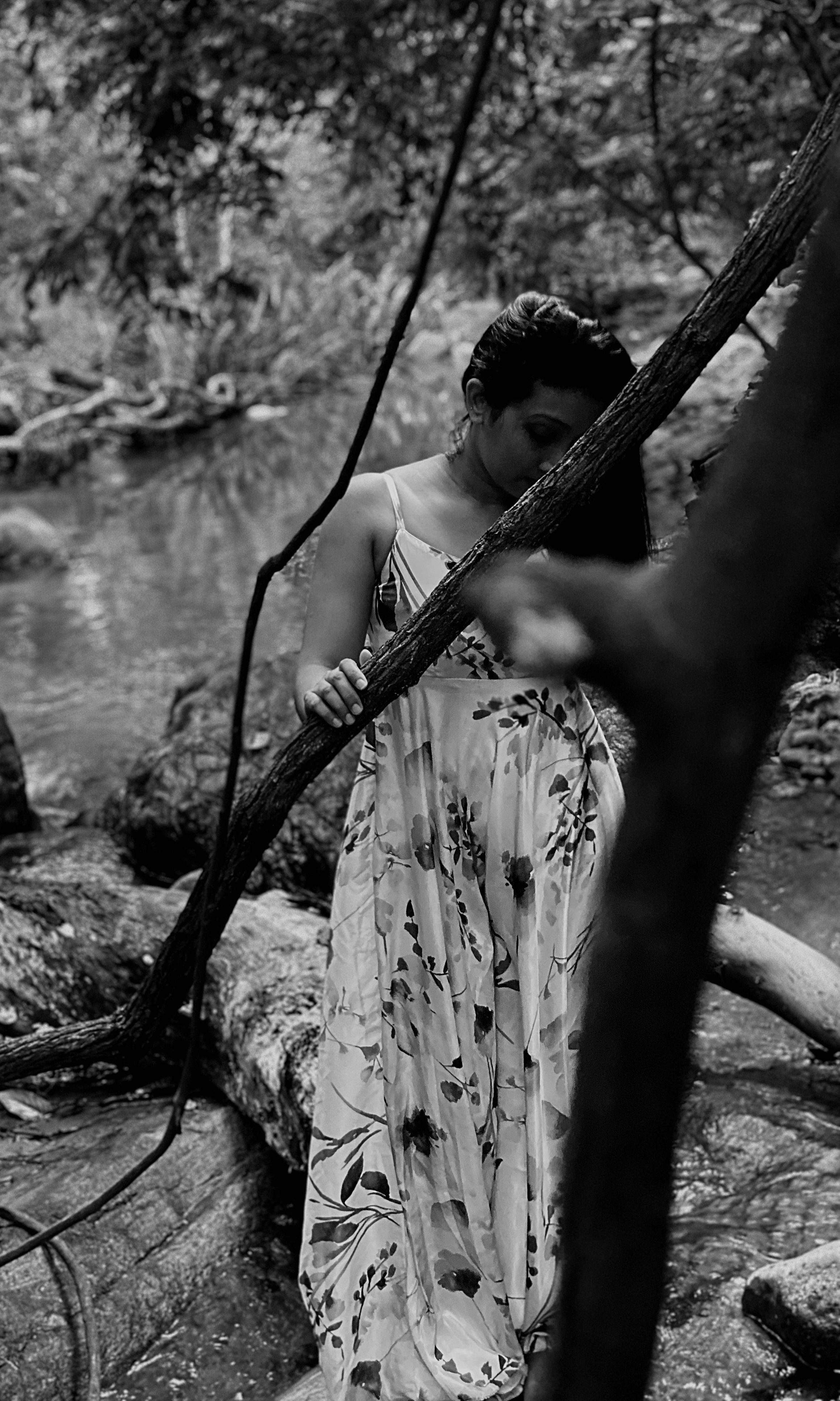 A Grayscale Photo of a Woman Wearing a Floral Dress · Free Stock Photo